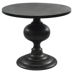 a round table with an iron base and black wood top, against a white background