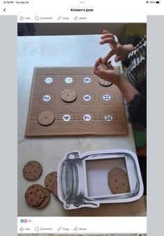 a cookie board with cookies on it next to an empty container and some magnets