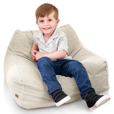 a young boy sitting on a bean bag chair