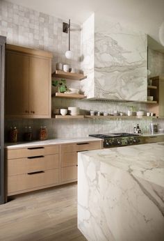 a kitchen with marble counter tops and wooden cabinets