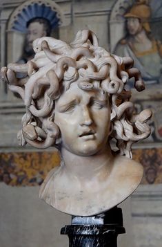 a marble bust of a woman with curly hair