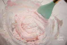 a mixing bowl filled with pink and white powder