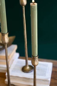 three candles are sitting on top of some books