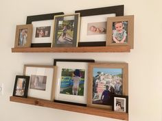 three wooden shelves with pictures and frames on them