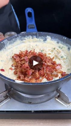 a pan filled with food sitting on top of a stove