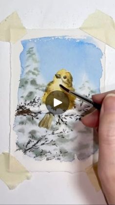 someone is painting a bird in the snow