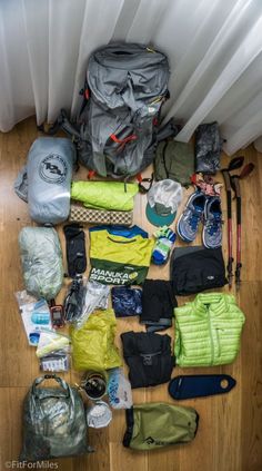 the contents of a backpack are laid out on the floor