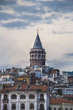 an old building with a steeple in the middle of it's roof tops