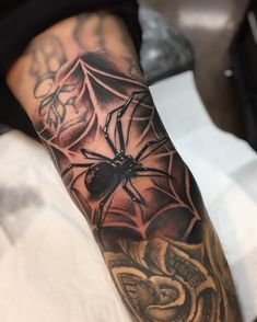 a man with a spider tattoo on his arm