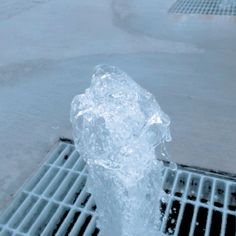 a fire hydrant spewing water out of it's sides