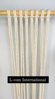 an image of a wall hanging with rope on it and the words l - com international