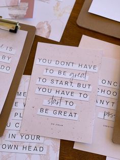 several pieces of paper with words on them sitting next to a pen and clipboard