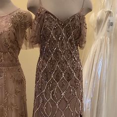 three dresses on mannequins in a store