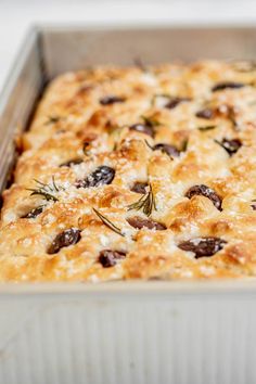 a casserole dish with olives and cheese