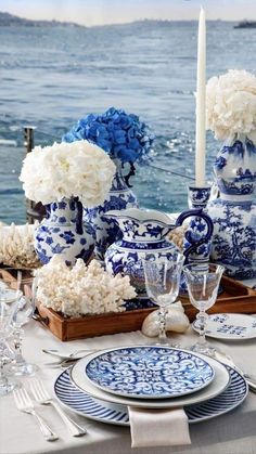 a table set with blue and white china