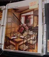 an open magazine showing a dining room and kitchen