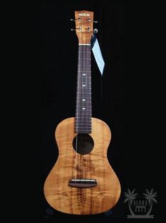 the ukulele is made out of wood and has a black background