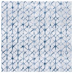 a blue and white rug with an abstract design