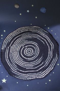 a large black and white basket sitting on top of a blue floor covered in stars