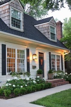 a white house with black shutters and windows