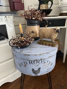 an old bucket with some plants in it and a candle sitting on top of it