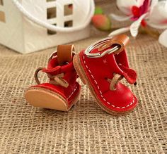 two little red shoes sitting on top of a table