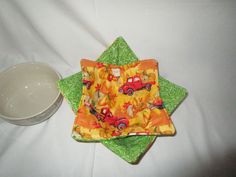 two plates and a bowl on a white tablecloth with a green star shaped napkin