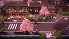 an aerial view of a city with lots of pink flowers on the trees and benches