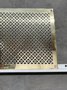 a metal grate sitting on top of a cement floor