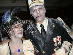 two people dressed up in costumes standing next to each other and one person with white paint on his face