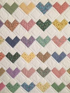 a quilt made with many different colors and patterns on it's sides, including the diagonal