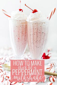 two glasses filled with peppermint milkshake on top of candy canes