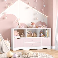 a child's room with pink walls and white furniture, including a doll house