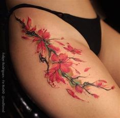 a woman's thigh with red flowers on it