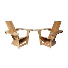 two wooden chairs sitting next to each other