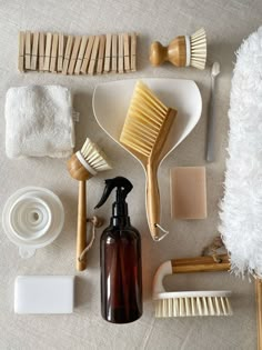 the contents of a personal care kit laid out on a white tablecloth, including hairbrushes, soaps, and toothpaste