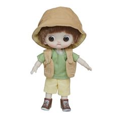 a small doll with a hood on it's head and legs, wearing yellow shorts and a green shirt