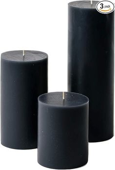 three black candles sitting next to each other