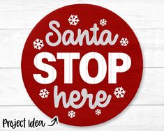 santa stop here sign with snowflakes on the bottom and white lettering in red