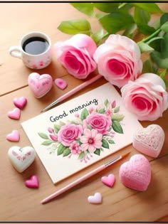 pink roses and hearts are on the table next to a card that says good morning