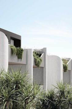 an architecturally designed building with plants growing on the balconies