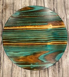 a round wooden table sitting on top of a wooden floor covered in wood planks