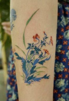 a close up of a person's arm with flowers on it