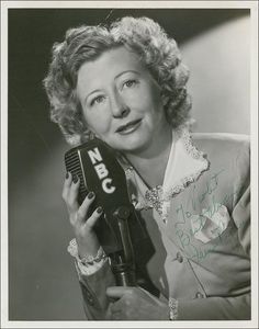 an old black and white photo of a woman holding a microphone