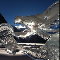 an ice sculpture with mountains in the background