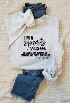 i'm a sports mom sweatshirt and jean shorts on top of a bed with the words, i'm a sports mom