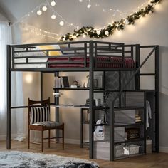 a loft bed with a desk underneath it and christmas lights hanging from the ceiling above