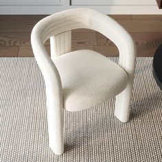 a white chair sitting on top of a rug