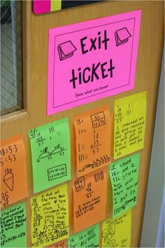 a bulletin board with sticky notes attached to it and an exit ticket on the door