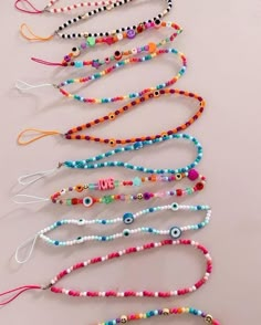 several bracelets are lined up on a table with beads in the shape of eyes